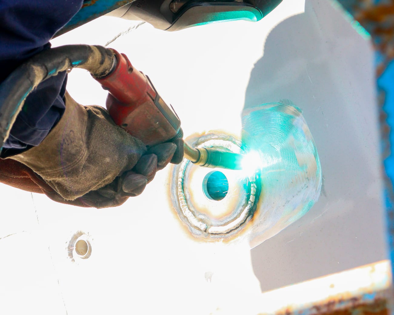 TIG welding a fitting onto a boat hull